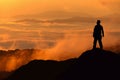 Silhouette of man standing on the top of mountain Royalty Free Stock Photo