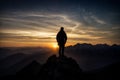 Silhouette of man standing on top of mountain and looking at sunset Royalty Free Stock Photo
