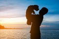 Silhouette of man standing on tropical beach with calm blue sea Royalty Free Stock Photo