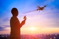 Silhouette of man take drone