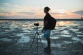 Silhouette of man taking photos with his camera at sunset Royalty Free Stock Photo