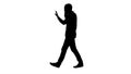 Silhouette Man talking on phone, walking and making gestures. Royalty Free Stock Photo