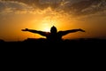 Silhouette of man with their hands in the sunset. Outdoor shot Royalty Free Stock Photo