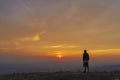 Silhouette of man on top of mountain at sunset Royalty Free Stock Photo