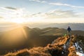 Silhouette of the man on top the peak of mountain on sunrise Royalty Free Stock Photo