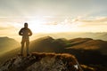 Silhouette of the man on top the peak of mountain on sunrise Royalty Free Stock Photo