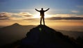 silhouette of a man on top who has reached the top of the mountain