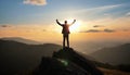 silhouette of a man on top who has reached the top of the mountain