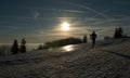 Silhouette of Man training on frozen trail with snow