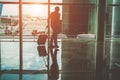 Silhouette man with trolley walking inside international airport - Entrepreneur business man going to the gates for airplane