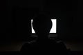 Silhouette of man using blank screen laptop in dark room Royalty Free Stock Photo