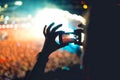 Silhouette of man using smartphone to take a video at a concert. Modern lifestyle with hipster taking pictures and videos