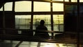 Silhouette of a man waiting for an airplane to departure with afternoon sunlight Royalty Free Stock Photo