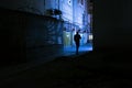 Silhouette of a man walking on an alley at night Royalty Free Stock Photo