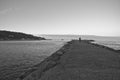 Silhouette of man walking on breakwater in sunset by atlantic ocean Royalty Free Stock Photo