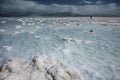 Silhouette of man walking on Dead Sea salt shore