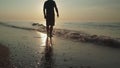 Silhouette a man walking peacefully along a deserted beach