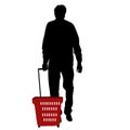 Silhouette of a man walking with shopping basket