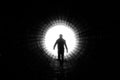 Silhouette of a man walking to the light at the end of a big tunnel. Concept of escape, exit, freedom, clinical death