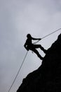 A silhouette of a man was climbing a ridge of hills