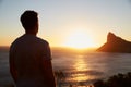 Silhouette Of Man Watching Sun Set Over Sea And Cliffs Royalty Free Stock Photo