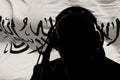 The silhouette of a man wearing headphones against the background of the Taliban flag, an eavesdropping secret agent, spy and inte Royalty Free Stock Photo