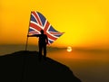 Silhouette man winner waving british flag on top of the mountain Royalty Free Stock Photo