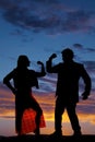 Silhouette man woman facing each other both flex one arm Royalty Free Stock Photo