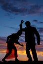 Silhouette man woman facing each other elbow on head Royalty Free Stock Photo