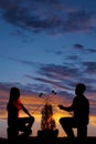 Silhouette man and woman hold up marshmallows Royalty Free Stock Photo