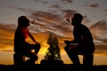 Silhouette man and woman with roasted marshmallows Royalty Free Stock Photo