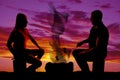 Silhouette man and woman roasting marshmallows Royalty Free Stock Photo