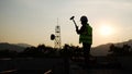 Silhouette of a man working at a construction site. Overtime labor. Work that is rushed and done on time