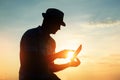 Silhouette man working on his laptop on the beach during sunset, freelancer concept in travel Royalty Free Stock Photo