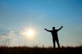 Silhouette of man worship with hands raised to the sky in nature Royalty Free Stock Photo