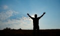 Silhouette of man worship with hands raised to the sky in nature Royalty Free Stock Photo