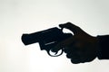 Silhouette of man& x27;s hand with revolver on white background. Royalty Free Stock Photo