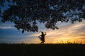 Silhouette Manohra women dance and tree with sunset in South of Thailand Royalty Free Stock Photo