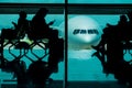 Silhouette of many Passengers Waiting for Boarding in Departure Terminal in the Airport Royalty Free Stock Photo