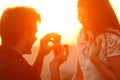 Silhouette of a marriage proposal at sunset