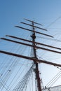 Silhouette of masts and rigging on an old sailboat under a blue sky Royalty Free Stock Photo