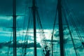 Silhouette of masts and ropes of a wooden old sailing ship against the background of the evening dark blue magical sky Royalty Free Stock Photo