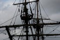 Silhouette of medieval boat against a dark stormy sky