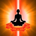 Silhouette of meditating person with sacral chakra symbol background Royalty Free Stock Photo