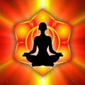 Silhouette of meditating person with sacral chakra symbol background