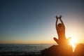 Silhouette meditation girl on the background of sea and amazing sunset. Royalty Free Stock Photo