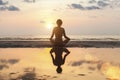 Silhouette meditation girl on the background of the stunning sea and sunset Royalty Free Stock Photo