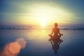 Silhouette meditation yoga woman on the background of the sea and amazing sunset Royalty Free Stock Photo