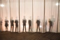 The silhouette of the men behind the curtain in the theater on stage, the shadow behind the scenes is similar to the white and bla Royalty Free Stock Photo