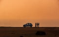 Silhouette of men and a car enjoying sea view from table top point at Devgad fort Royalty Free Stock Photo